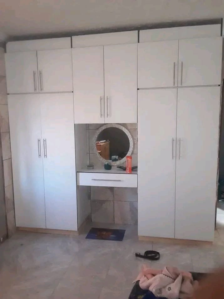 Custom TV unit and floating shelves in a lounge